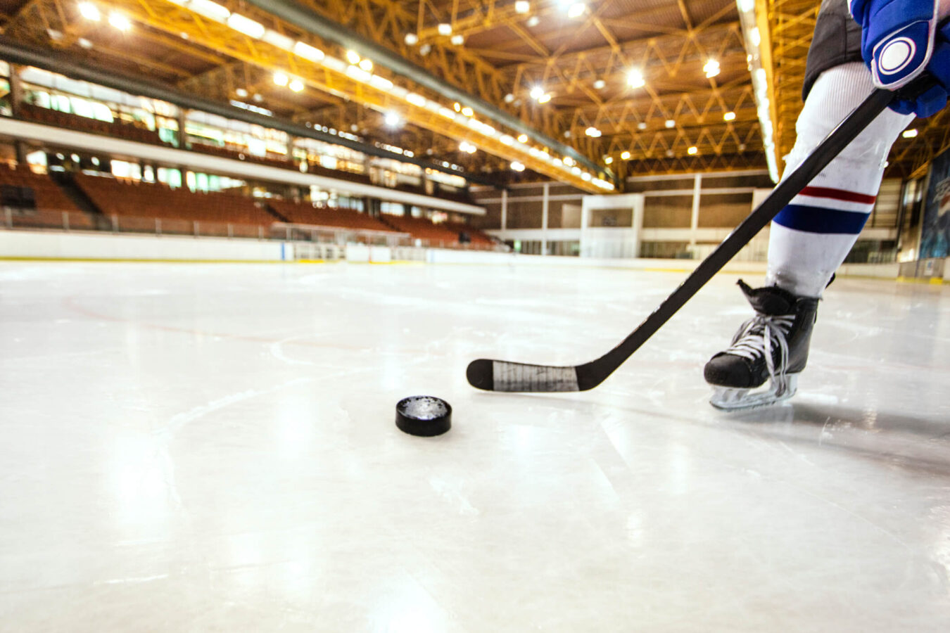 athlete playing hockey in ice rink